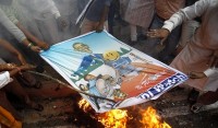Reuters picture of Indian Protesters burning FDI Watch poster in effigy Indian Protesters burning FDI poster at demonstration