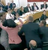 images Wendi Murdoch in pink fighting off the shaving cream pie heading for Murdoch's face.