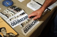 A Tea Party member reaches for a pamphlet at a "Food for Free Minds Tea Party Rally" in Littleton