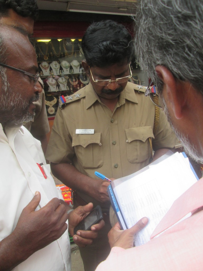 talking to a police harassing us that is in Chennai in the Mint Road market