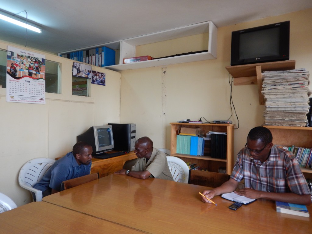 ACORN organizers, Sammy and David, prepare for COPA Kenya meeting with chair of ACORN Kenya