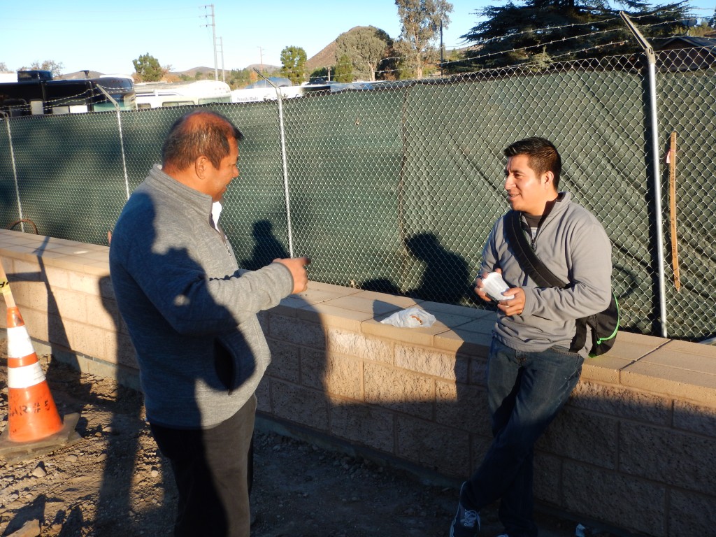 Pablo telling a young worker about the history of the site while he waits for work