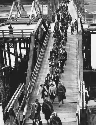 Japanese-American residents of Bainbridge Island, Washington, boarded a ferry to Seattle. From there, they were transferred to a camp in California. Photocredit: Ryan Williams for The New York Times