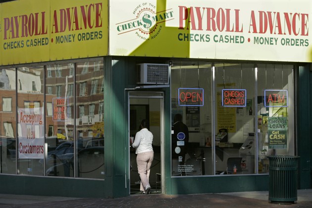 A customer enters a Payroll Advance location in Cincinnati. (Al Behrman / AP)