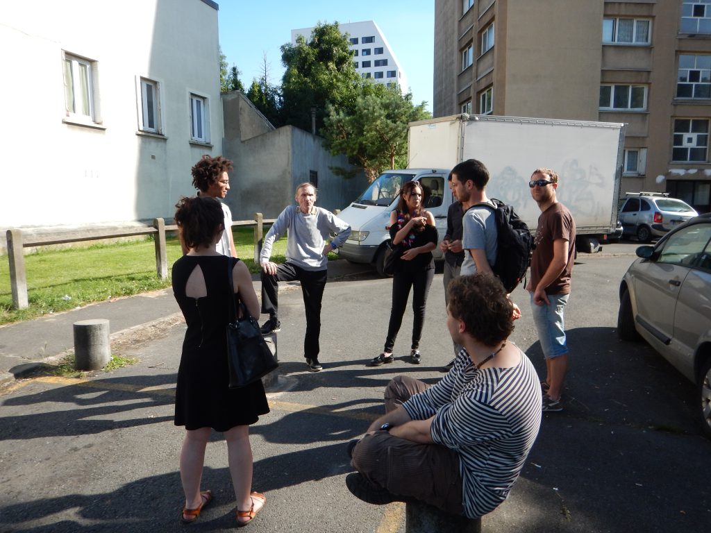 organizers talking to leaders and looking at the parking barrier still waiting for repairs