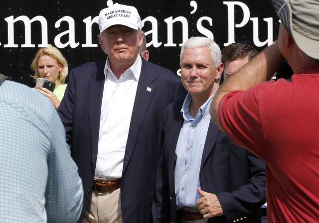Republican presidential nominee Donald Trump and Republican U.S. vice presidential candidate Mike Pence speak with flood victims outside Greenwell Springs Baptist Church in Central, Louisiana, U.S. August 19, 2016. REUTERS/Jonathan Bachman