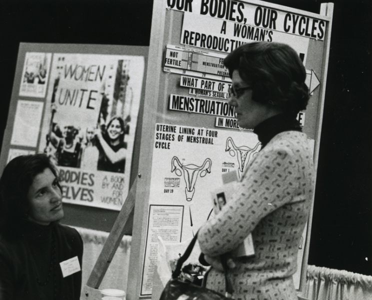 Norma Swenson and Betsy Cole at an exhibit booth for Our Bodies, Ourselves